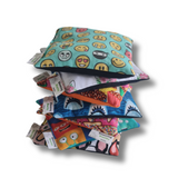 Handmade Kids Heat & Cold Pack featuring a dinosaur print, filled with Australian-grown lupin seeds for natural relief from bumps, bruises and growing pains.
