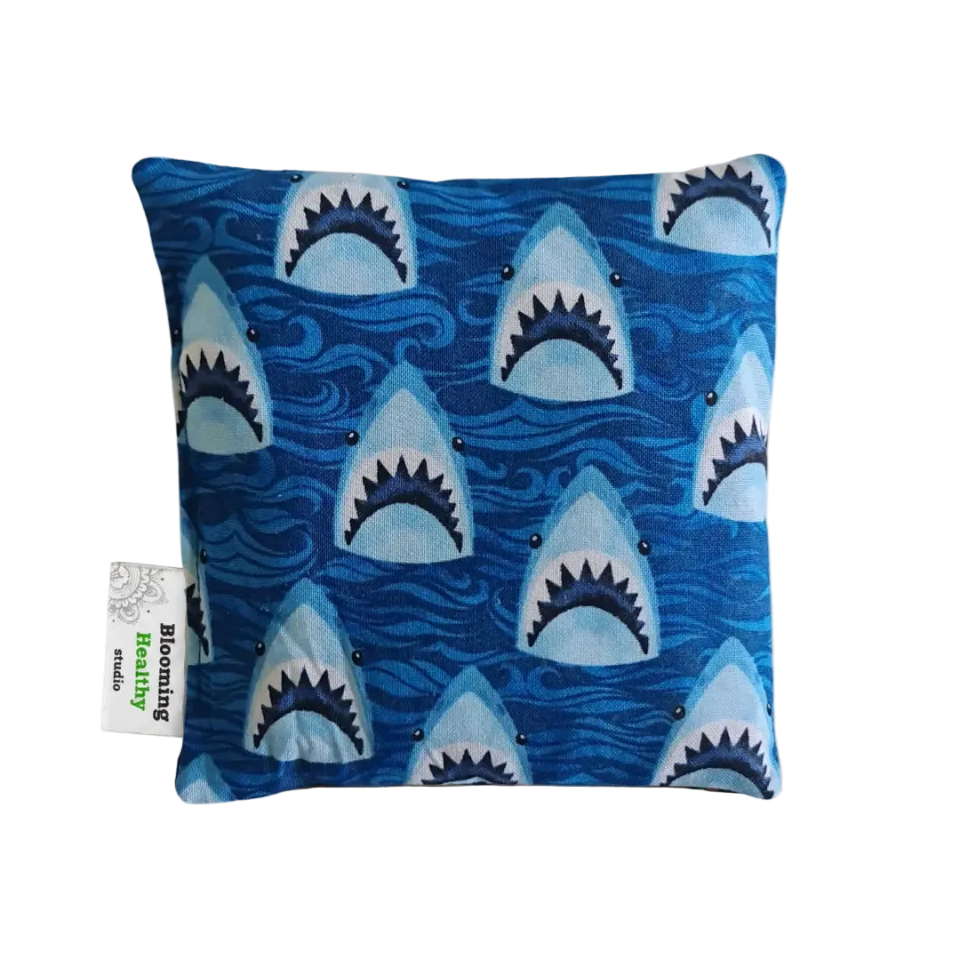 Handmade Kids Heat & Cold Pack featuring a shark print, filled with Australian-grown lupin seeds for natural relief from bumps, bruises and growing pains.