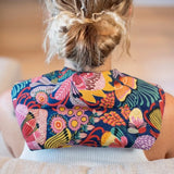 Colourful Australian floral neck heat pack filled with lupin seeds, worn across the shoulders for hot or cold therapy