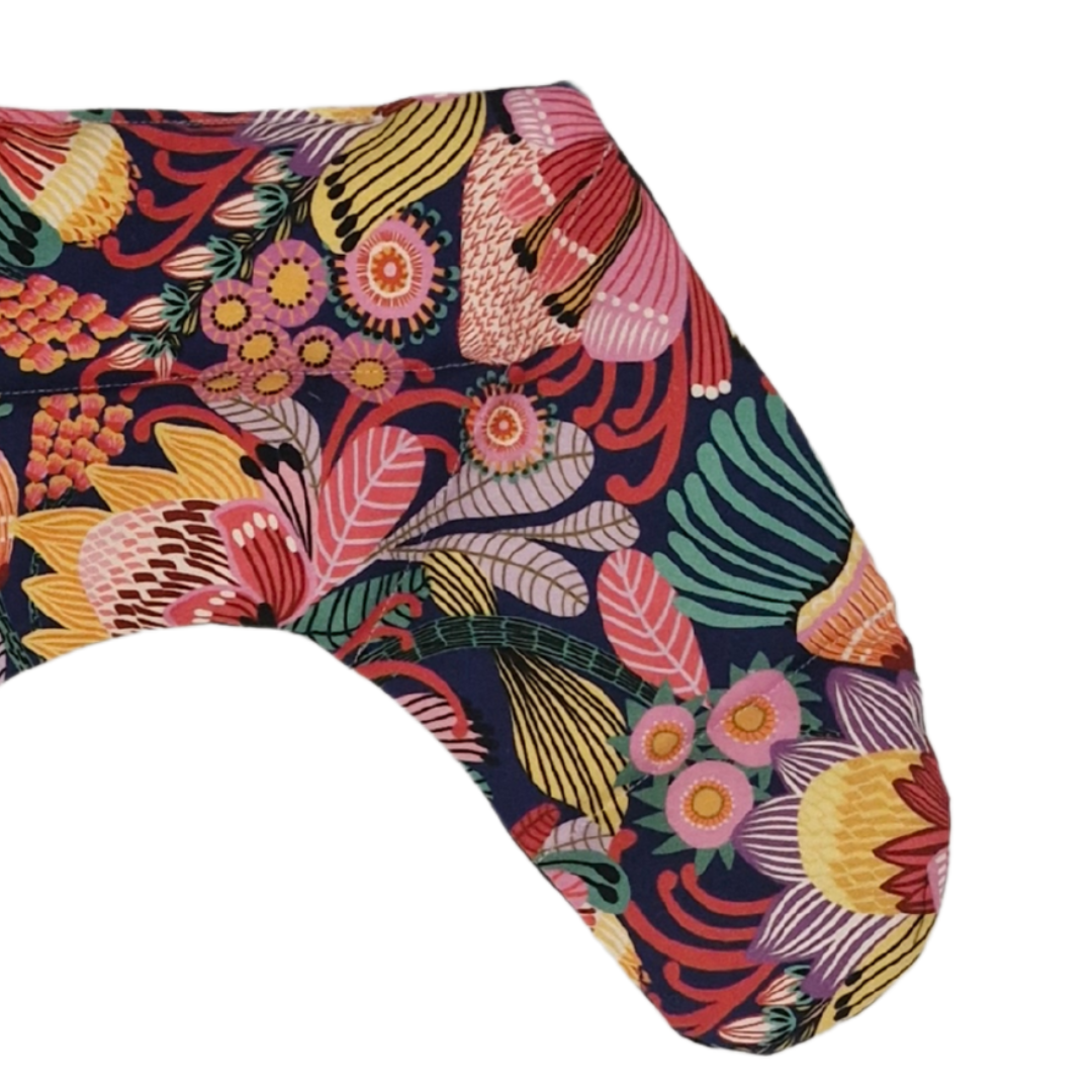 Colourful Australian floral neck heat pack filled with lupin seeds, worn across the shoulders for hot or cold therapy