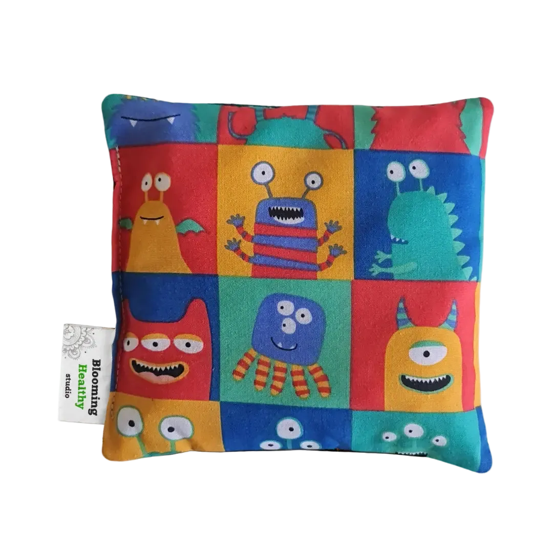 Handmade Kids Heat & Cold Pack featuring a happy monster print, filled with Australian-grown lupin seeds for natural relief from bumps, bruises and growing pains.